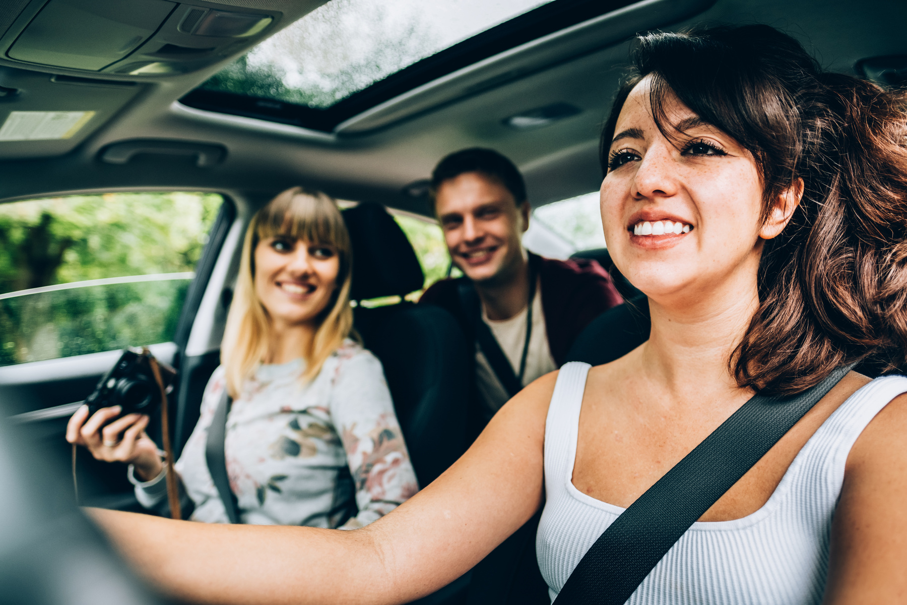 Friends enjoying a ride in a rental car