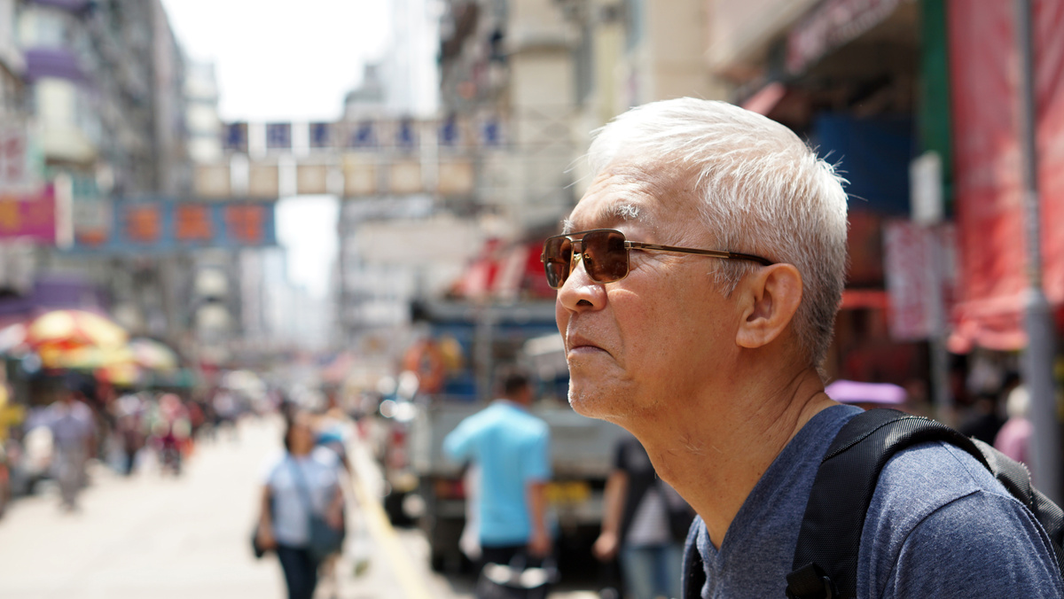 senior man with hong kong urban architecture scene