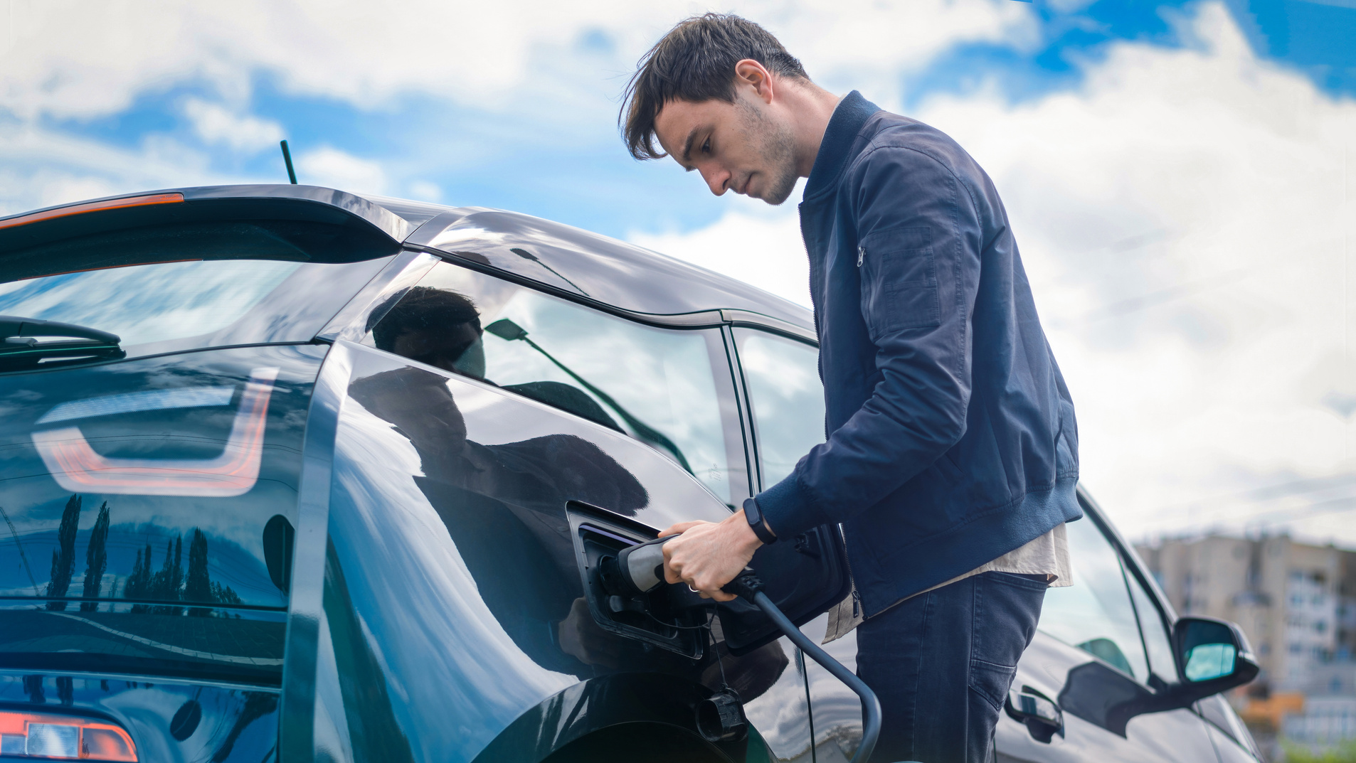 Man Charging Electric Car